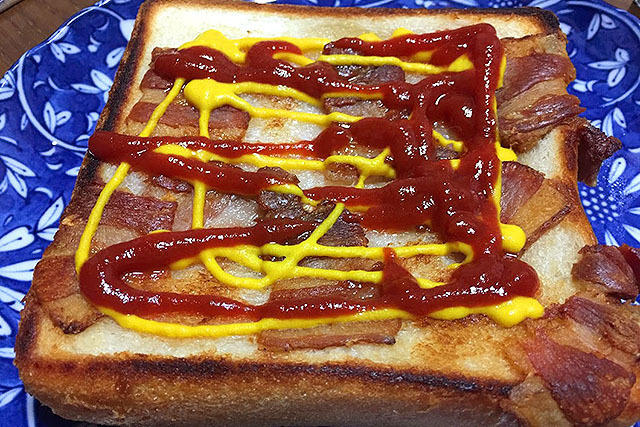 Bacon on one side of the bread.