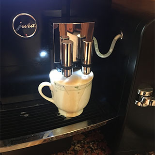 The espresso machine overflowed because we carelessly pressed the button without reading the instructions